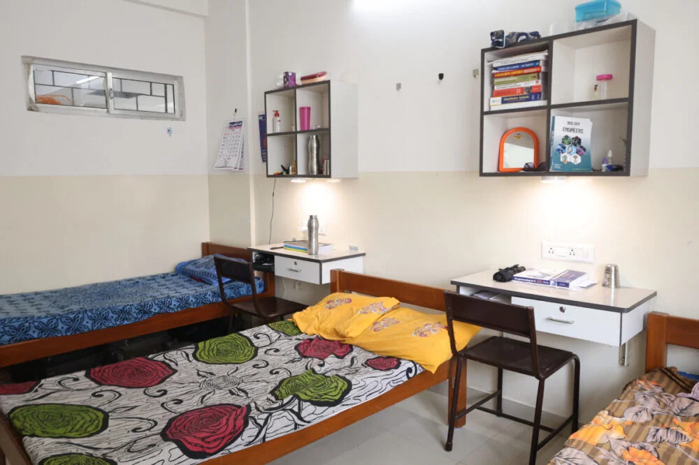 Hostel room with beds and study tables
